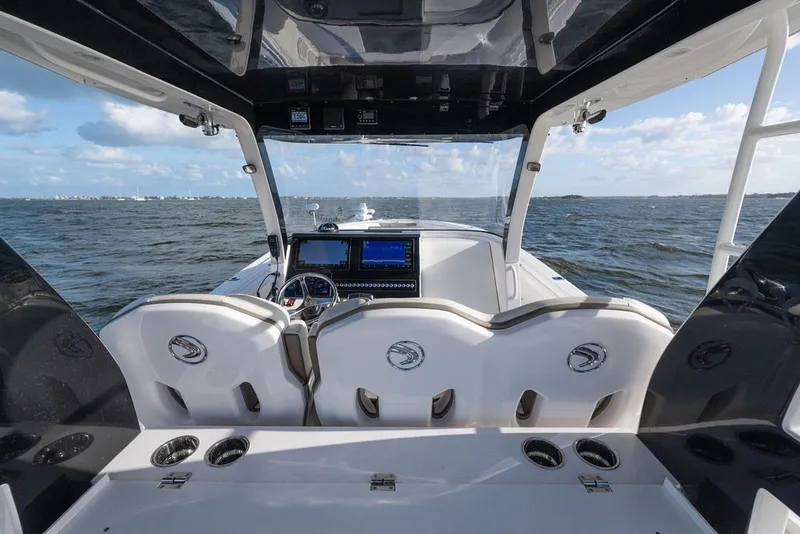 Slide: The Image of Interior view of 2020 Edgewater 370CC boat with helm and ocean backdrop. - 16