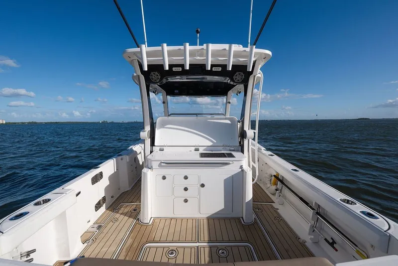Slide: The Image of 2020 Edgewater 370CC boat on open water, featuring spacious deck and modern design. - 52