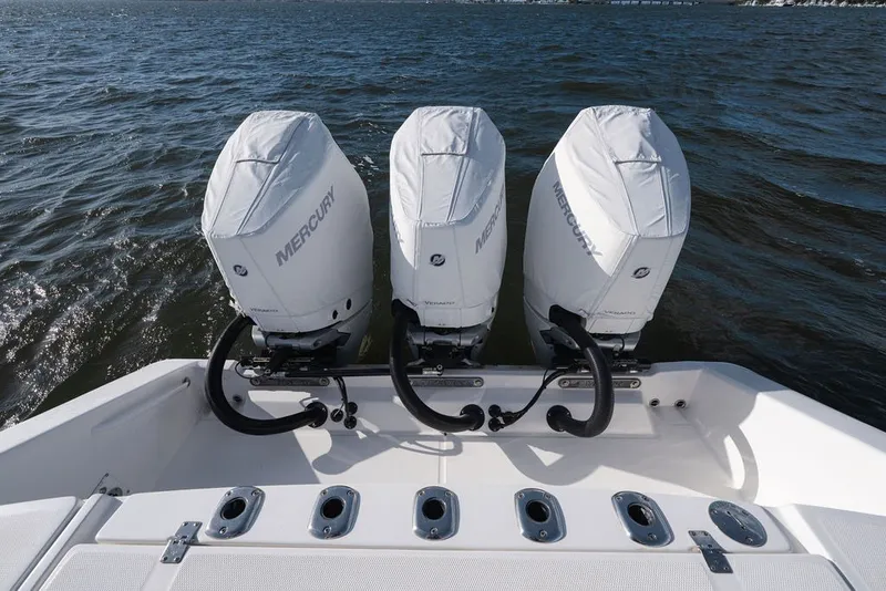 Slide: The Image of Triple Mercury outboard engines on a 2020 Edgewater 370CC boat, cruising on open water. - 42