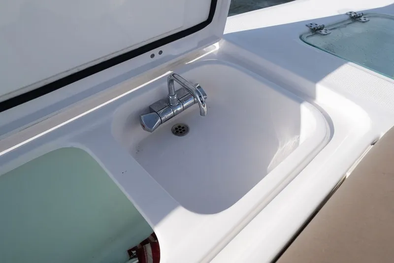 Slide: The Image of Edgewater 370CC 2020 boat sink with chrome faucet in open compartment. - 45