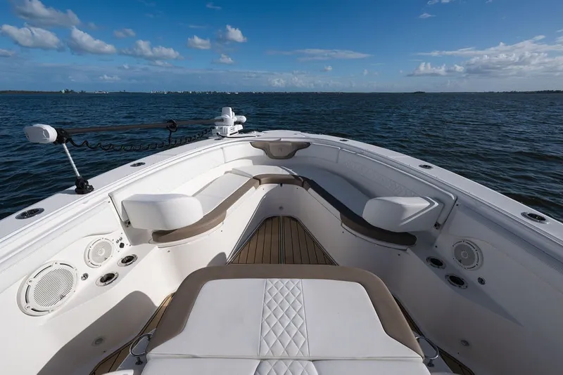 Slide: The Image of 2020 Edgewater 370CC boat interior with seating, on open water under blue sky. - 63