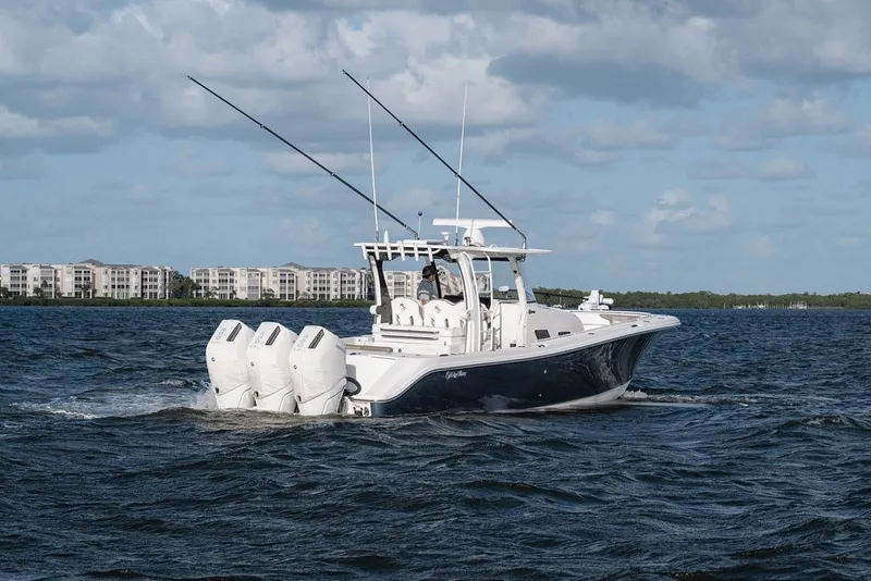 Slide: The Image of Edgewater 370CC 2020 boat cruising on open water with three engines. - 6