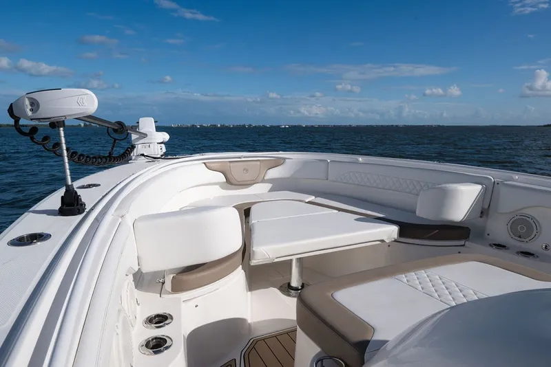 Slide: The Image of Edgewater 370CC 2020 boat interior with seating, table, and ocean view. - 60