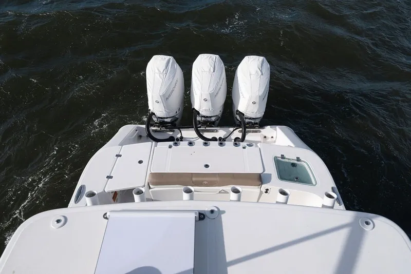 Slide: The Image of 2020 Edgewater 370CC boat with triple outboard engines on water. - 27