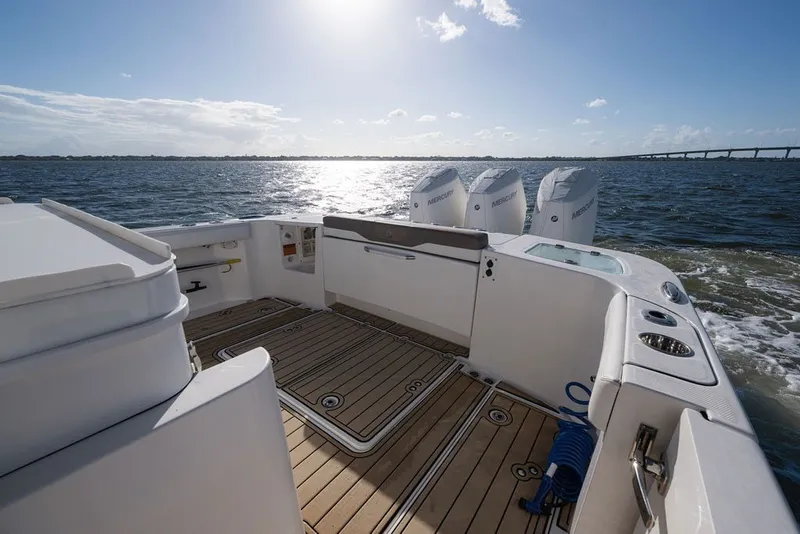 Slide: The Image of Edgewater 370CC 2020 boat with triple Mercury engines on open water. - 54