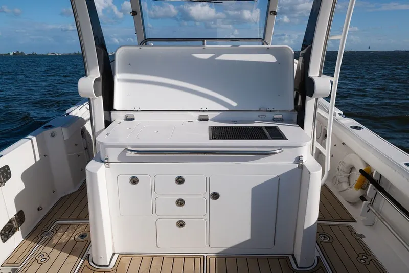 Slide: The Image of 2020 Edgewater 370CC boat interior with sleek cabinetry and ocean view. - 51