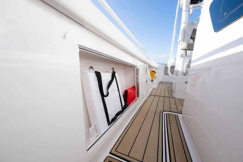 Slide: The Image of 2020 Edgewater 370CC boat storage compartment with safety equipment on deck. - 44