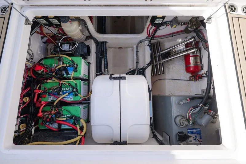 Slide: The Image of 2020 Edgewater 370CC boat engine compartment with batteries, wiring, and fire extinguisher. - 70