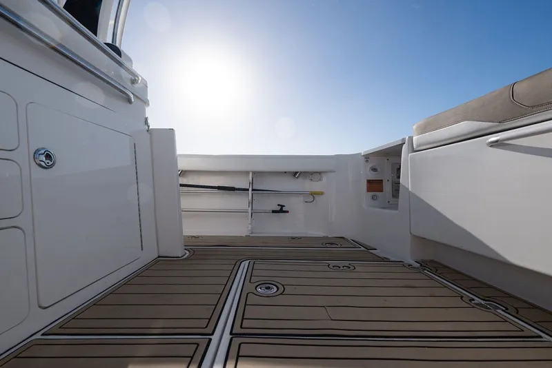 Slide: The Image of 2020 Edgewater 370CC boat interior with sunlit deck and seating. - 22