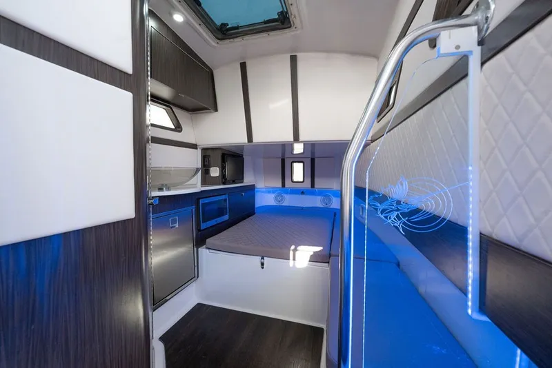 Slide: The Image of Luxurious interior of a 2020 Edgewater 370CC boat with modern amenities and blue accent lighting. - 37