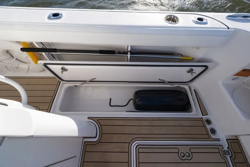 Slide: The Image of 2020 Edgewater 370CC boat storage compartment with open hatch and equipment inside. - 47