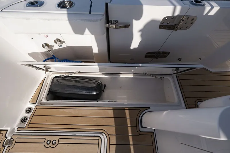 Slide: The Image of Storage compartment on 2020 Edgewater 370CC boat with teak flooring and stainless steel fixtures. - 48