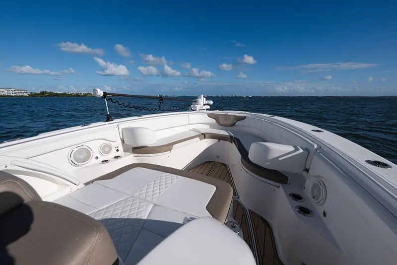Slide: The Image of 2020 Edgewater 370CC boat interior with seating, on a sunny day at sea. - 65
