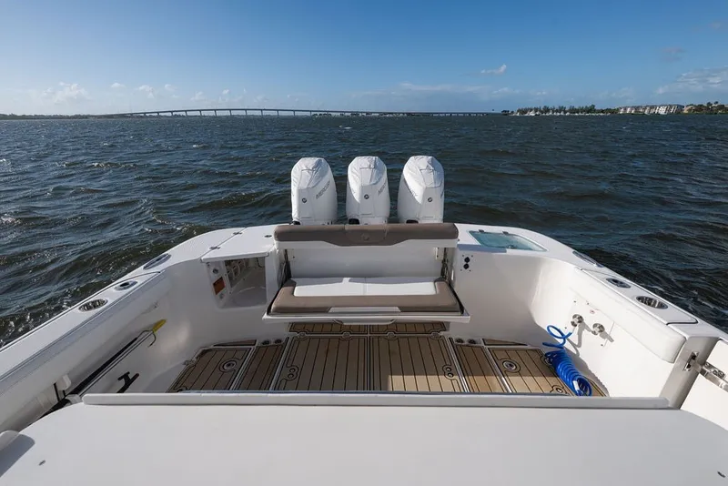 Slide: The Image of 2020 Edgewater 370CC boat with triple engines on open water. - 23