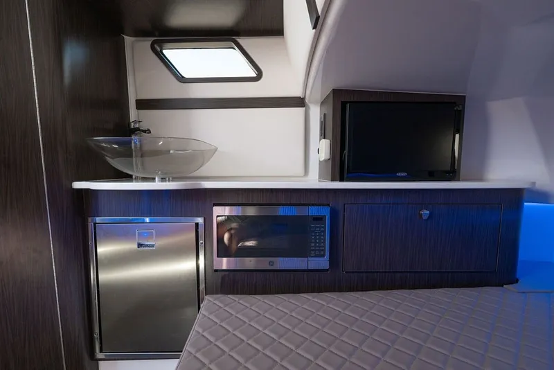 Slide: The Image of Interior of 2020 Edgewater 370CC boat with modern kitchenette and appliances. - 36