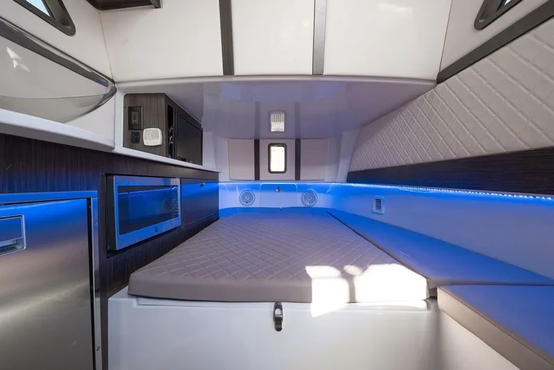 Slide: The Image of Interior cabin of 2020 Edgewater 370CC boat with modern amenities and blue LED lighting. - 35