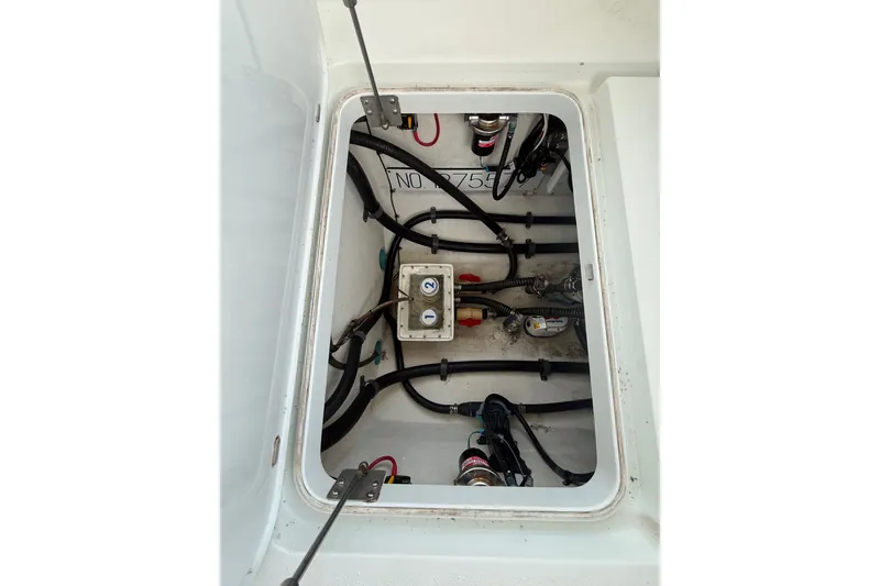 Slide: The Image of 2014 Yellowfin 32 Offshore boat compartment with wiring and mechanical components. - 17