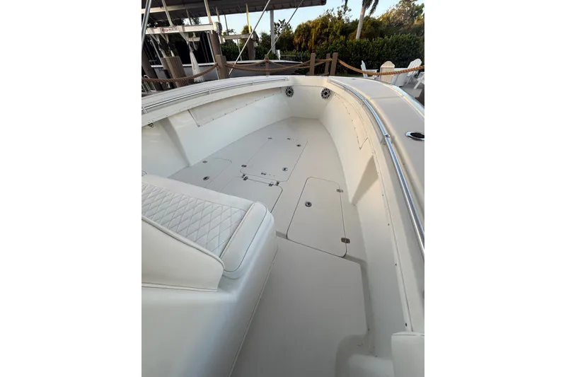Slide: The Image of 2014 Yellowfin 32 Offshore boat interior with white seating and spacious deck. - 13