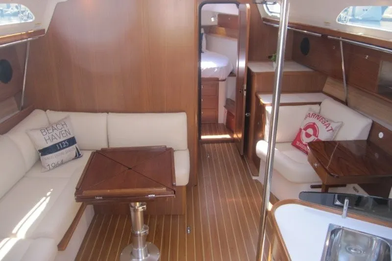 Slide: The Image of Luxurious interior of 2025 Catalina 386 yacht with wooden flooring and comfortable seating. - 21