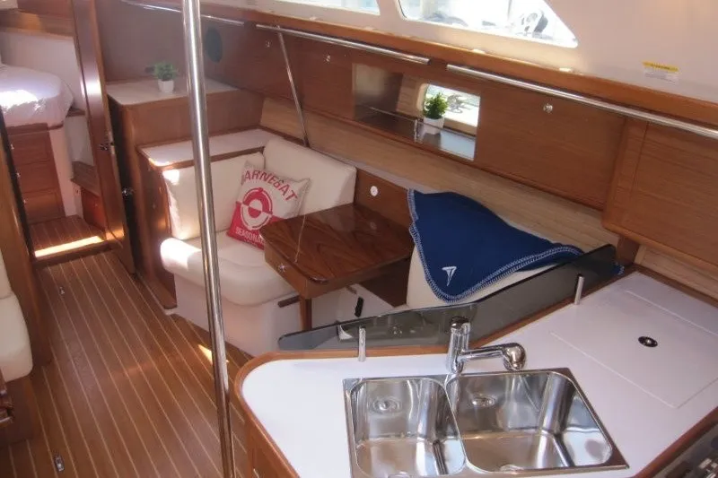 Slide: The Image of Interior of 2025 Catalina 386 sailboat with modern kitchen and cozy seating area. - 22