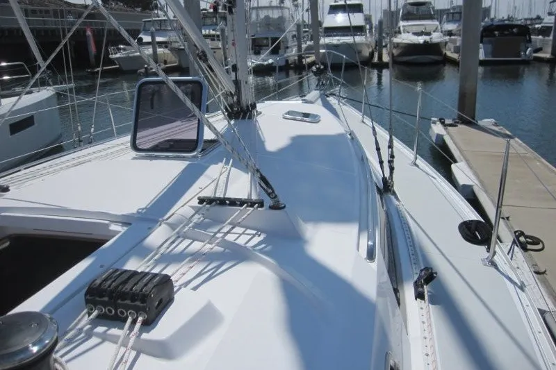 Slide: The Image of Sailboat deck view of 2025 Catalina 386, docked in a marina with other boats. - 45