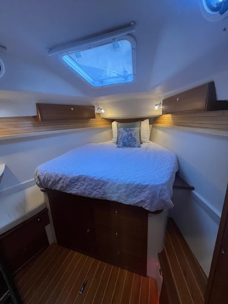 Slide: The Image of Cozy cabin interior of 2025 Catalina 386 sailboat with skylight and wooden accents. - 12