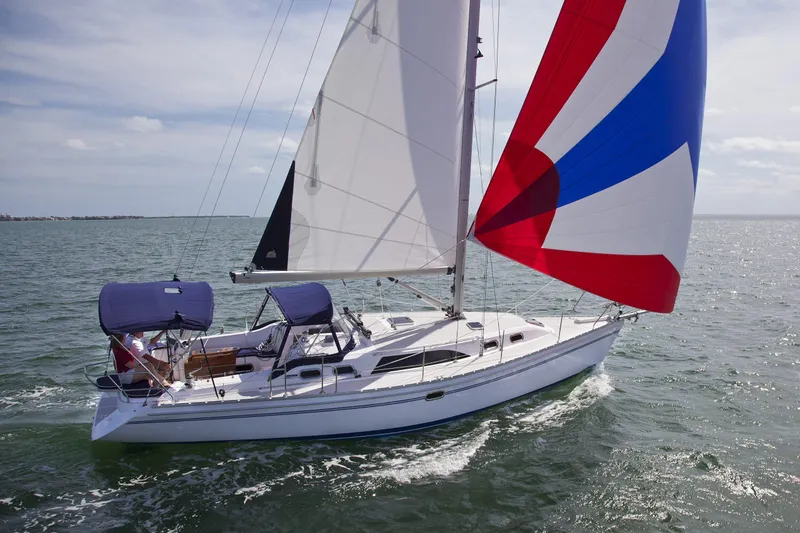 Slide: The Image of 2025 Catalina 386 sailboat cruising on open water with colorful sails. - 55