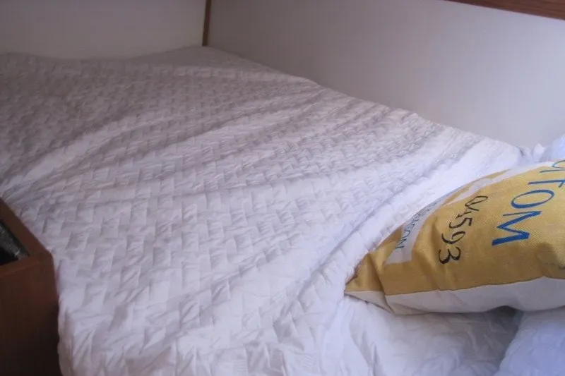 Slide: The Image of Cozy bed with white quilt and decorative pillow in Catalina 386, 2025 model. - 34