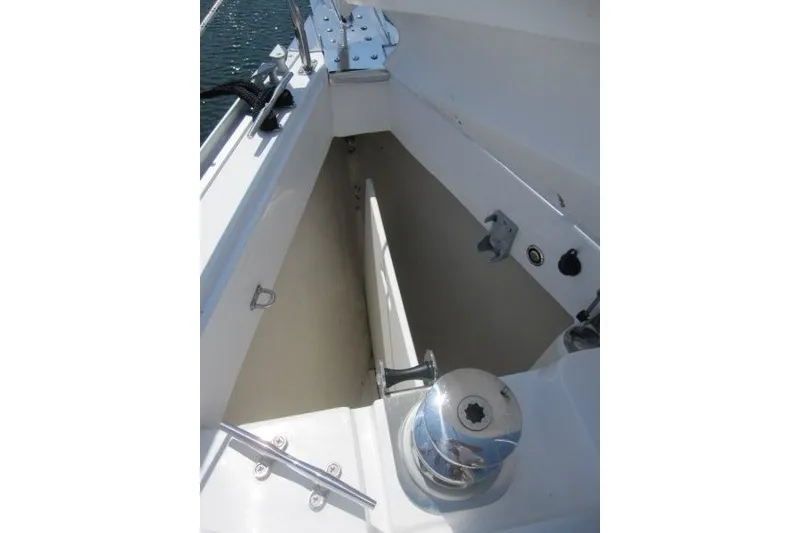 Slide: The Image of Anchor locker of 2025 Catalina 386 sailboat, featuring winch and cleats. - 47