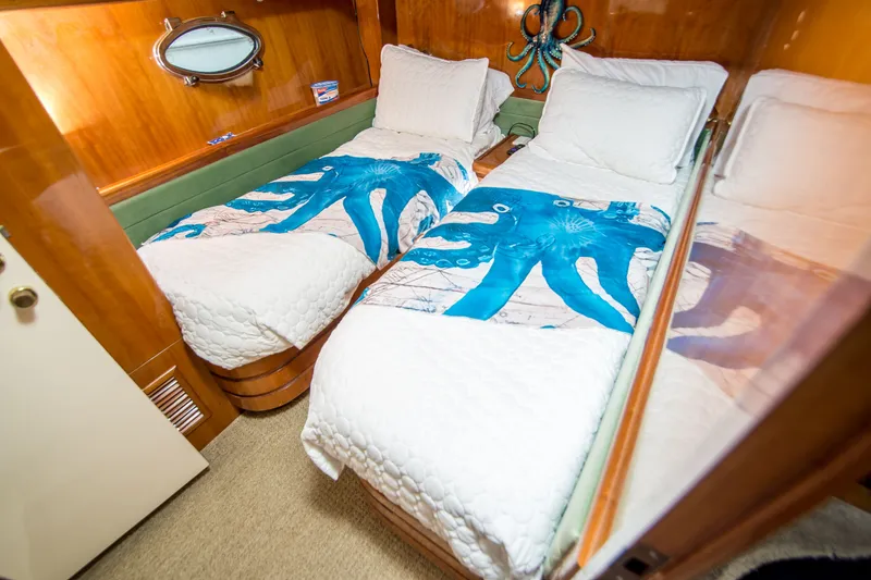 Slide: The Image of Twin beds with octopus-themed bedding in a 2000 Johnson 58 yacht cabin. - 14