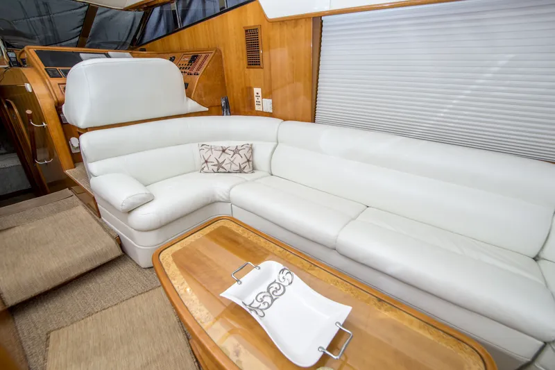 Slide: The Image of Luxurious interior of a 2000 Johnson 58 yacht with white leather seating and wooden accents. - 27