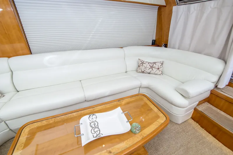 Slide: The Image of Luxurious white leather seating area in a 2000 Johnson 58 yacht interior. - 28