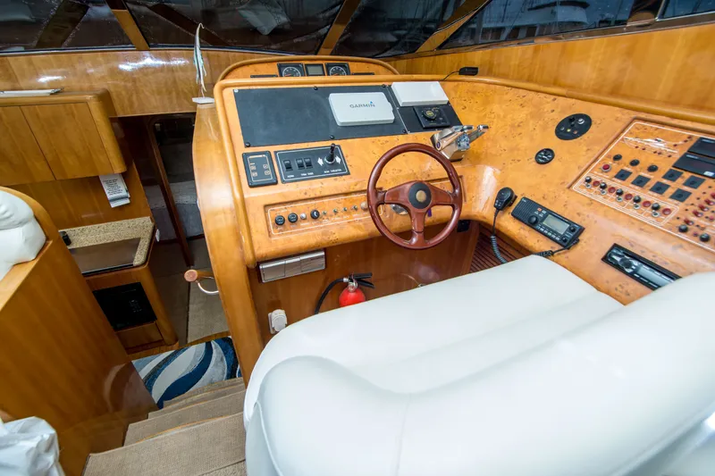 Slide: The Image of Luxurious Johnson 58 yacht helm with wood finish and modern controls, year 2000 model. - 20