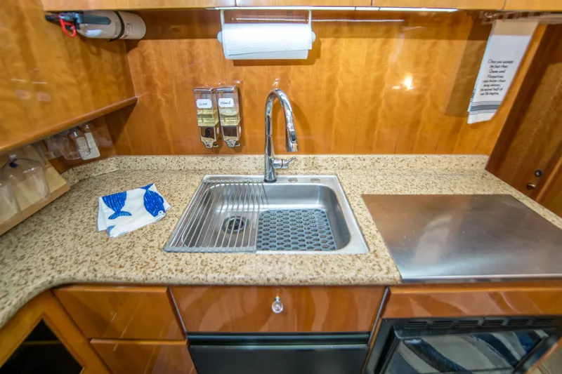 Slide: The Image of Johnson 58 yacht kitchen with granite countertop, stainless steel sink, and modern fixtures, year 2000. - 19