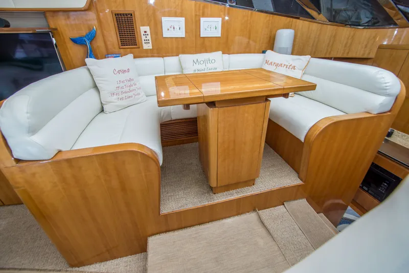 Slide: The Image of Luxurious Johnson 58 yacht interior with cozy seating and wooden table, year 2000 model. - 24
