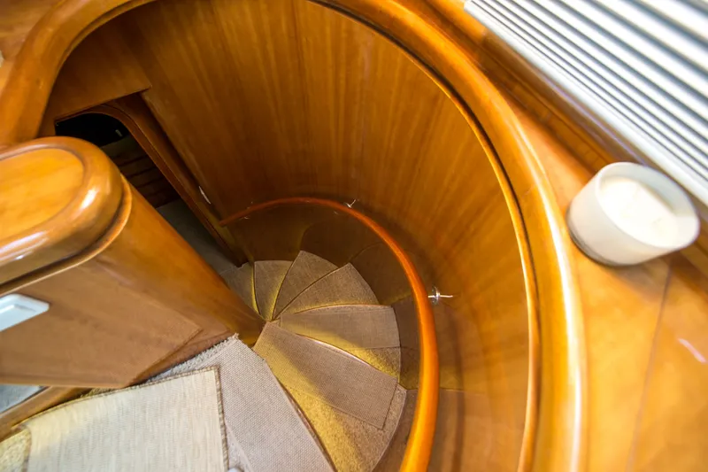 Slide: The Image of Spiral staircase with wooden finish inside a 2000 Johnson 58 yacht. - 30