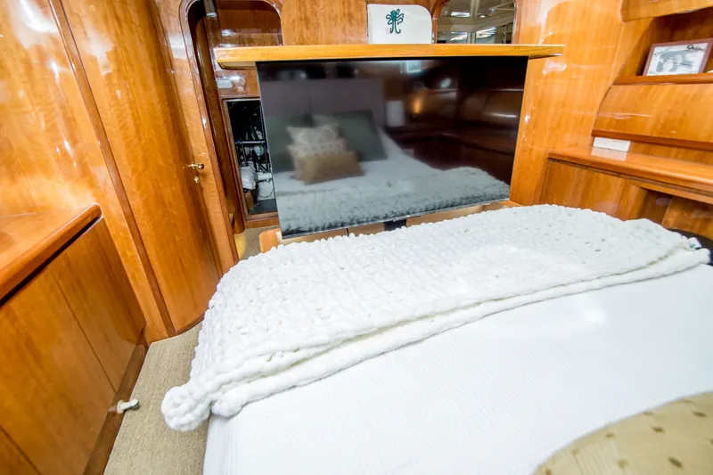 Slide: The Image of Luxurious cabin interior of a 2000 Johnson 58 yacht with wooden finishes and cozy bedding. - 31