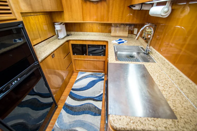 Slide: The Image of Luxurious yacht kitchen with granite countertops, stainless steel sink, and modern appliances. Johnson 58, 2000. - 18