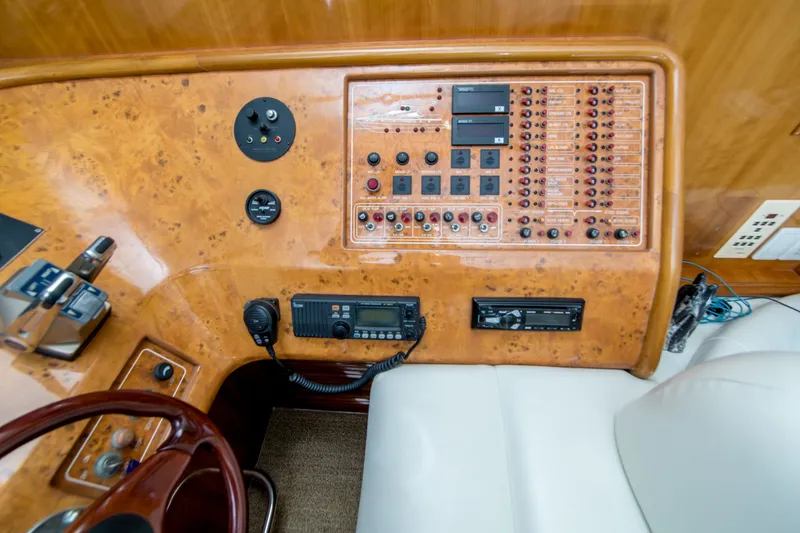 Slide: The Image of Control panel of a 2000 Johnson 58 yacht with various switches and instruments. - 22