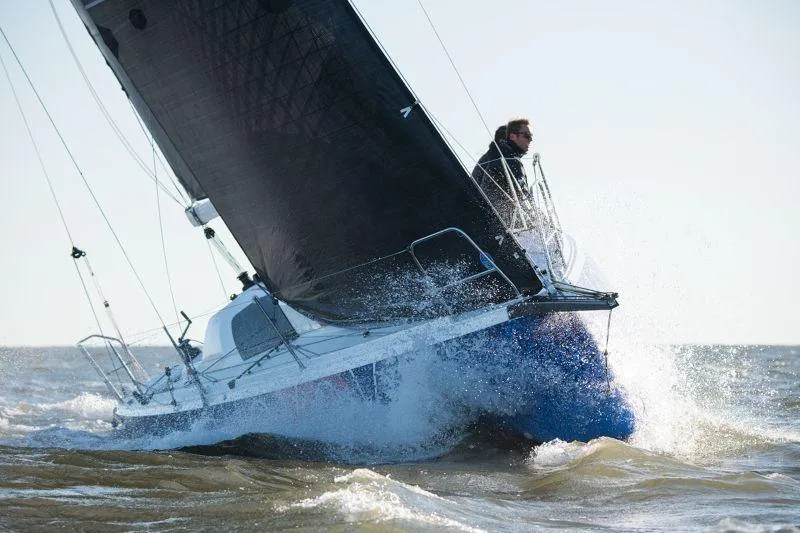 Slide: The Image of 2025 Jeanneau Sun Fast 3300 sailing through waves, showcasing speed and performance. - 16