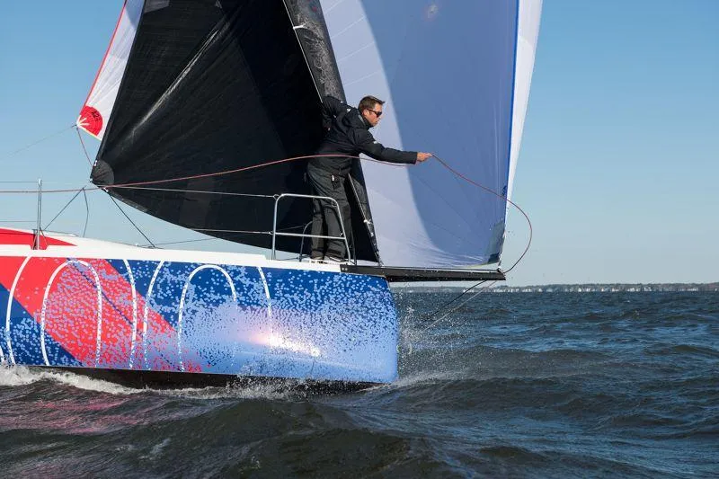 Slide: The Image of 2025 Jeanneau Sun Fast 3300 sailing on open water, vibrant hull design. - 22