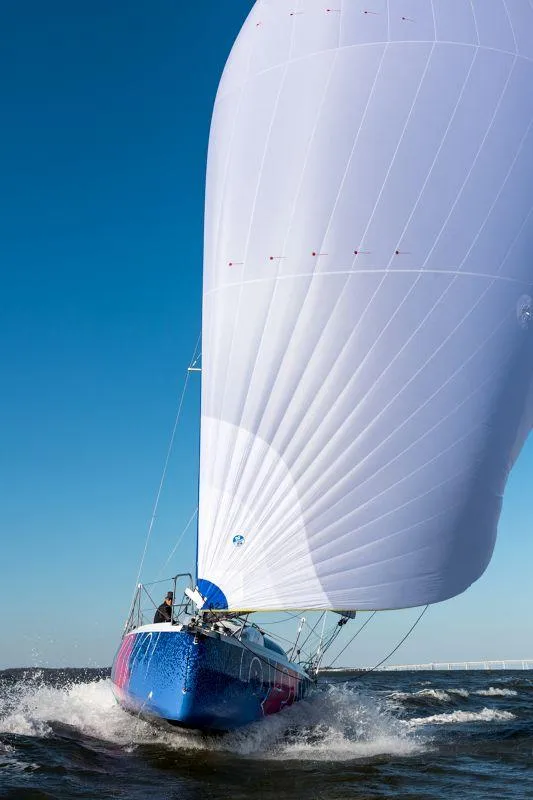 Slide: The Image of 2025 Jeanneau Sun Fast 3300 sailing with full spinnaker on open water. - 24