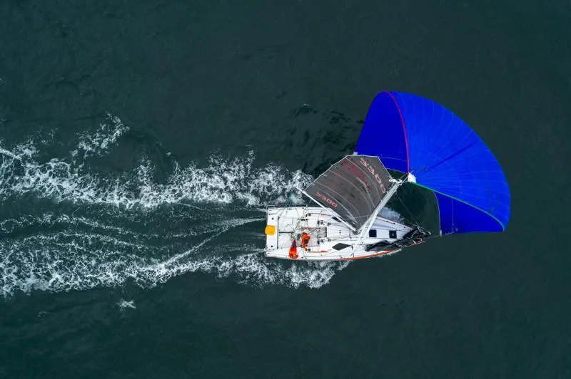 Slide: The Image of Aerial view of 2025 Jeanneau Sun Fast 3300 sailing with blue spinnaker. - 36