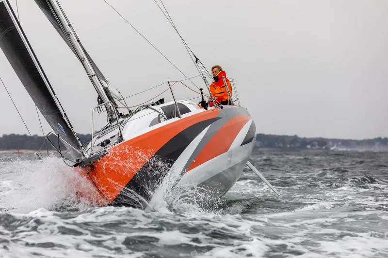 Slide: The Image of 2025 Jeanneau Sun Fast 3300 sailing in rough waters, vibrant orange and black design. - 30