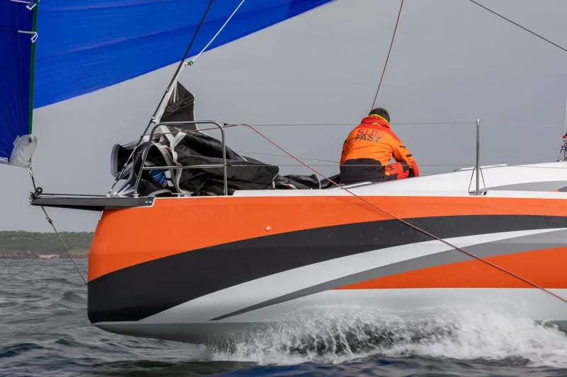 Slide: The Image of 2025 Jeanneau Sun Fast 3300 sailing with vibrant orange and black design. - 31