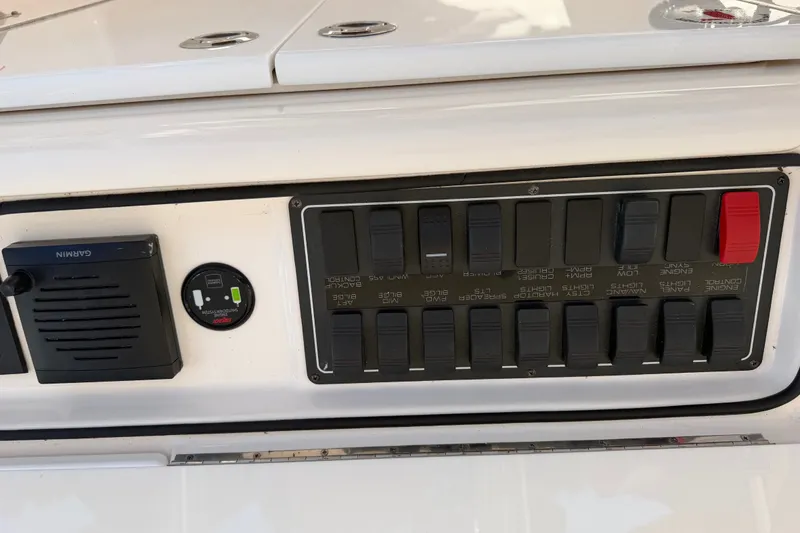 Slide: The Image of Control panel of a 2017 Tiara Yachts 39 Convertible boat with switches and Garmin device. - 40