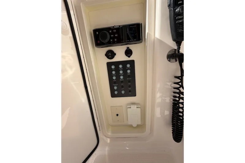 Slide: The Image of Control panel of a 2017 Tiara Yachts 39 Convertible, featuring audio and communication systems. - 39