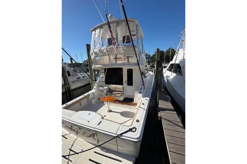 Slide: The Image of 2017 Tiara Yachts 39 Convertible docked, showcasing spacious deck and flybridge. - 19