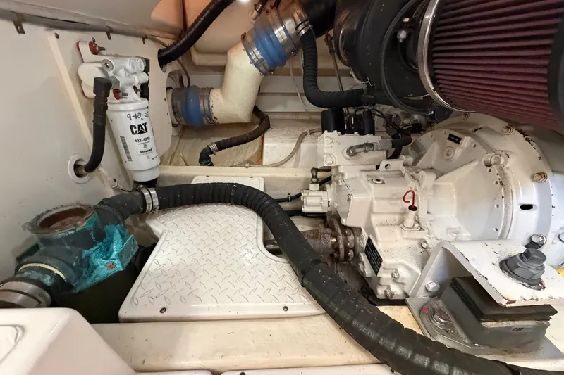 Slide: The Image of Engine room of a 2017 Tiara Yachts 39 Convertible, showcasing mechanical components and filters. - 26