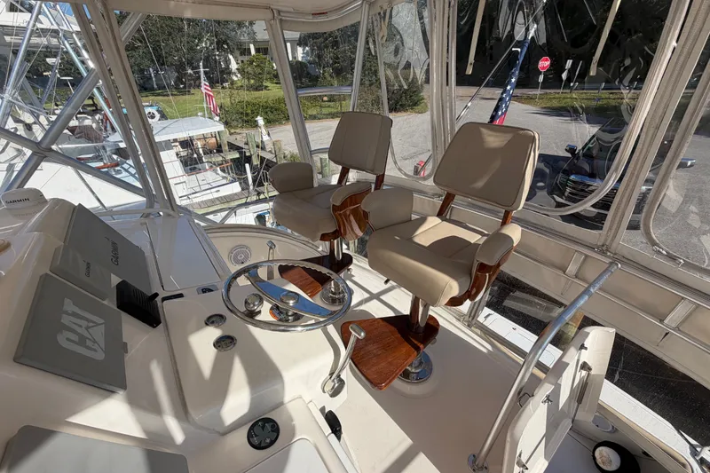 Slide: The Image of Helm of 2017 Tiara Yachts 39 Convertible with dual captain chairs and navigation equipment. - 31